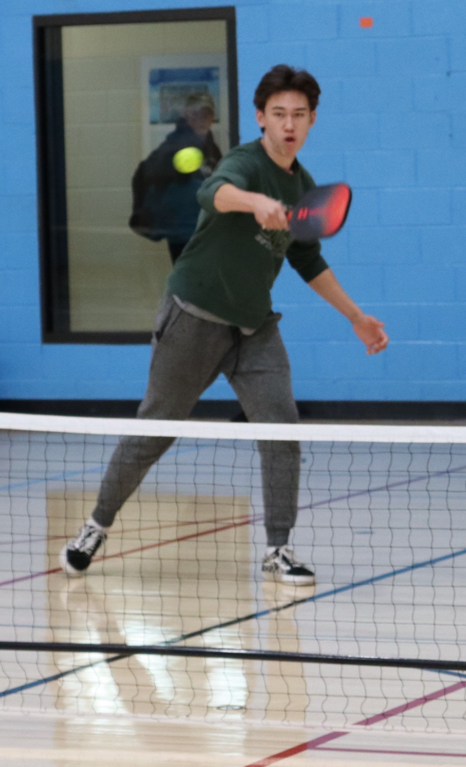 young man playing pickleball